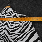 Ruler across the shoulders of black and white zebra-print Erin London blazer