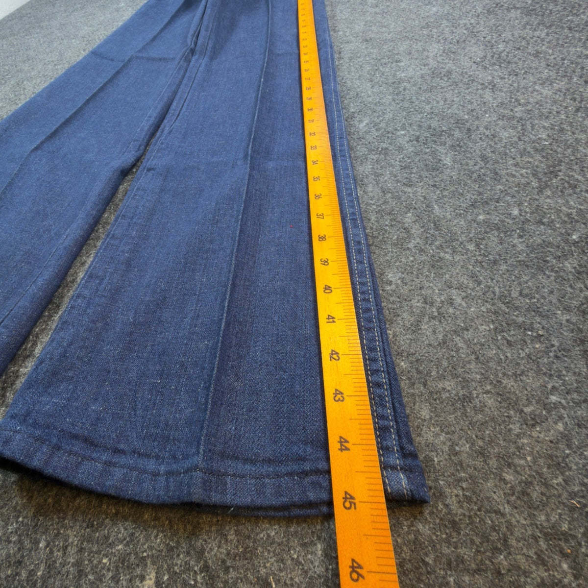 Blue Maverick flared jeans with embroidered horses at back waist, outer length ruler view