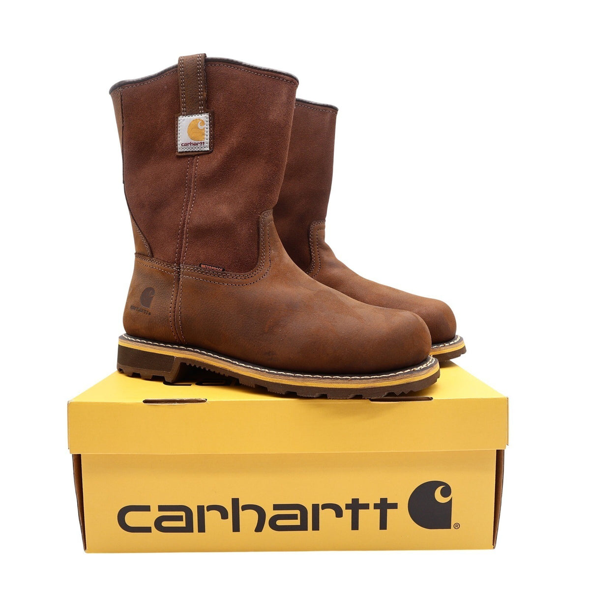 Brown Carhartt pull-on work boots, pair on yellow Carhartt box