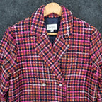 Pink, orange and navy AURA plaid double-breasted coat, close-up of collar, lapels and upper buttons