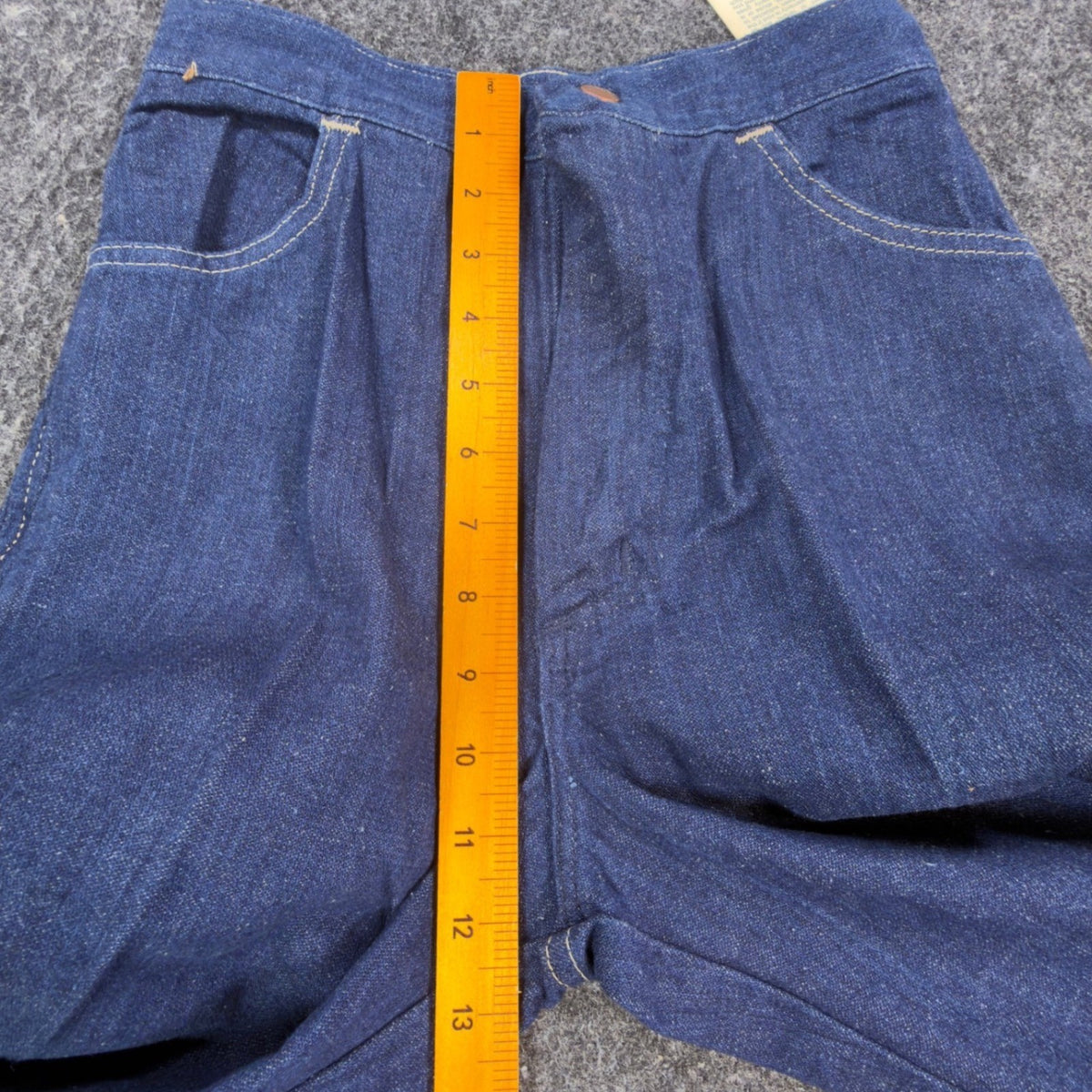 Blue Maverick flared jeans with embroidered horses at back waist, front rise ruler view