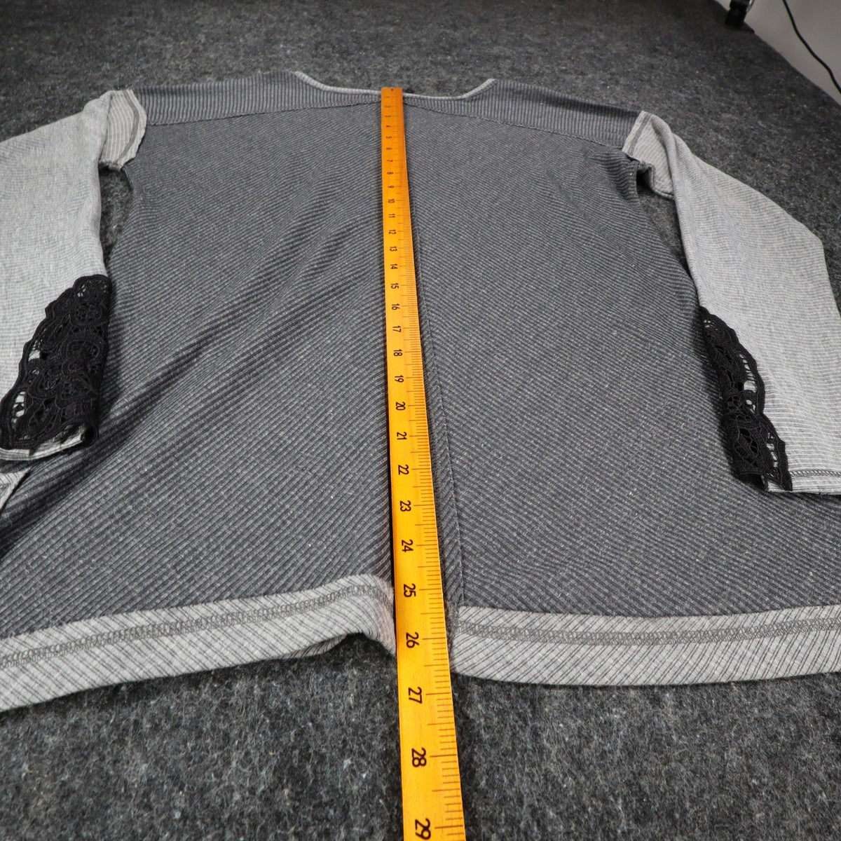 Gray Hem & Thread top with pale sleeves and black lace cuffs, back length ruler view