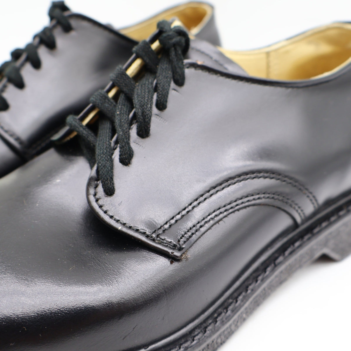 Black Cedar Crest plain-toe lace-up shoes, laces and stitching close-up