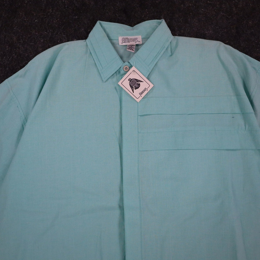Close-up of the collar and pleated chest panel of an aqua blue Alexxus short-sleeve shirt