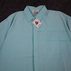 Close-up of the collar and pleated chest panel of an aqua blue Alexxus short-sleeve shirt