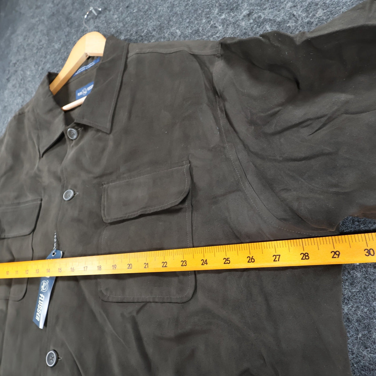 Ruler across the chest of brown Alan Flusser button-front shirt jacket
