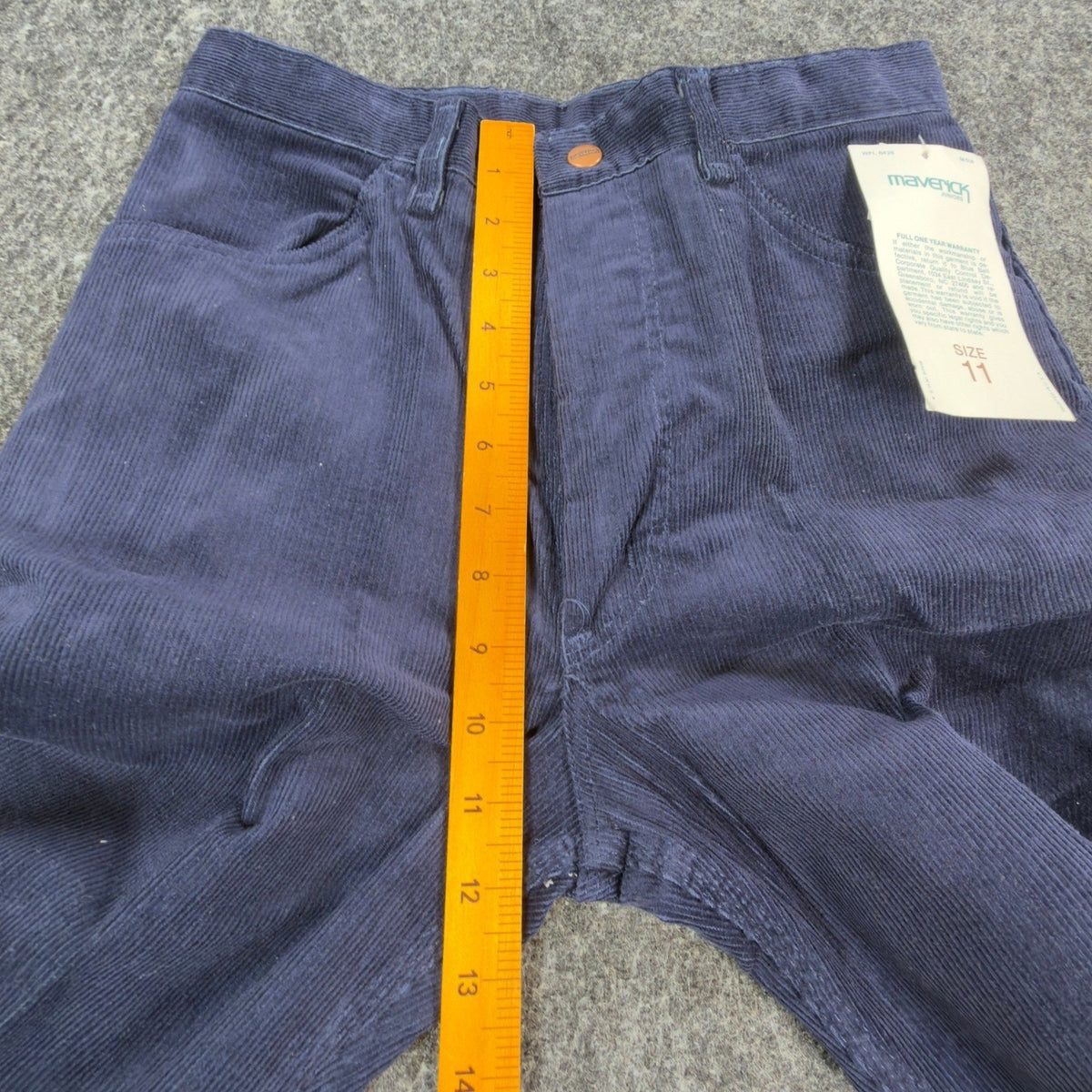 Navy Maverick flared corduroy pants, front rise ruler view