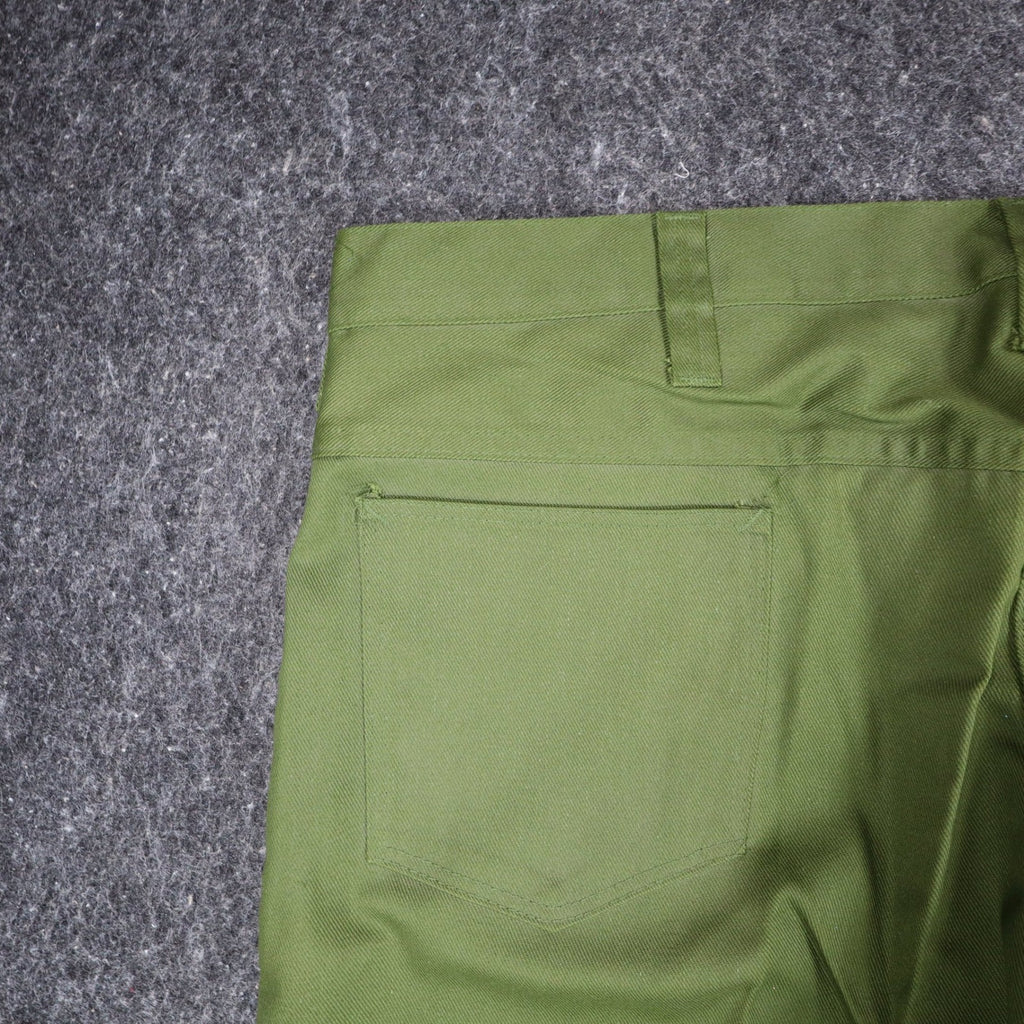 Close-up of a back patch pocket and belt loop on green Aldens pants