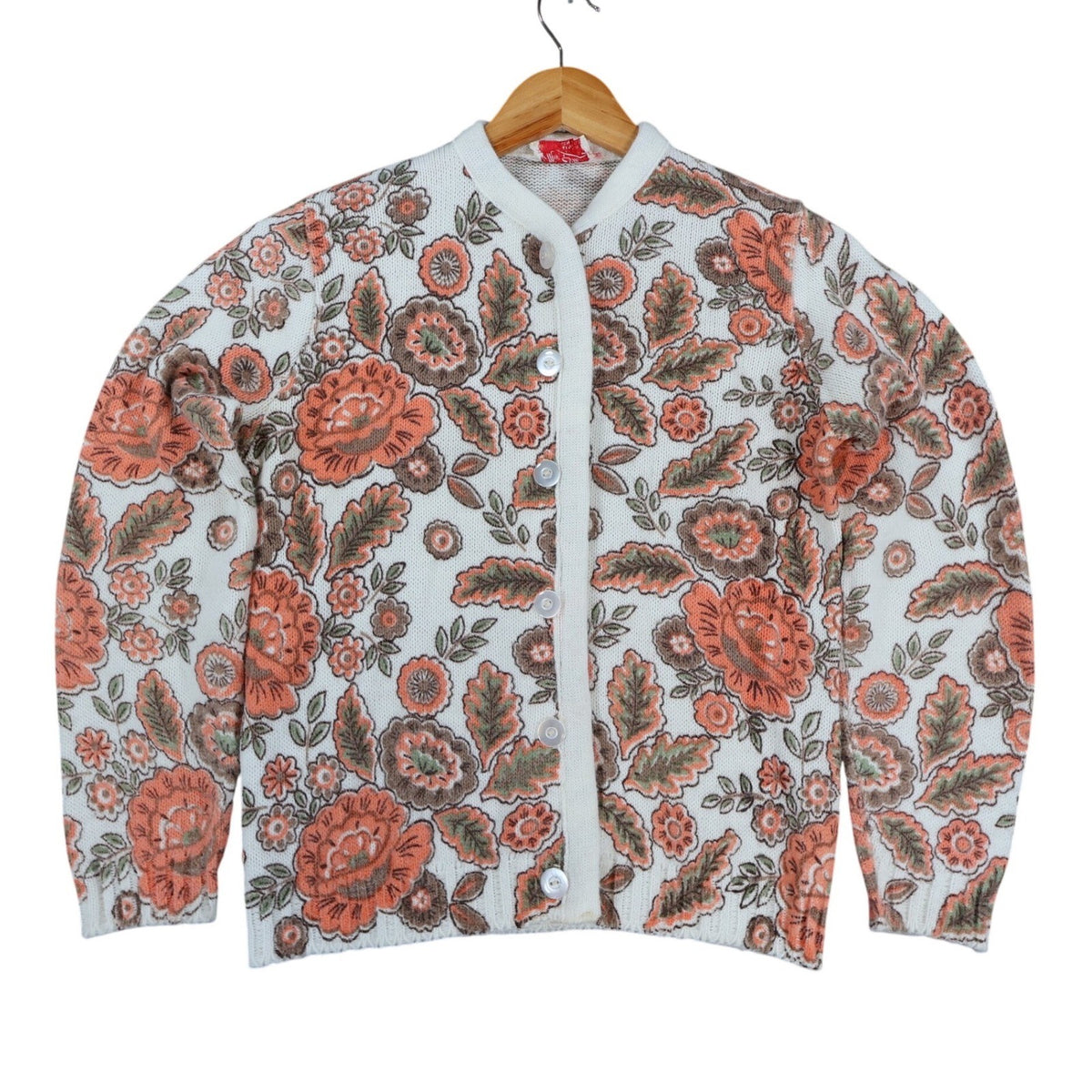 White Miss Sue floral-print cardigan, front view on hanger with orange flowers and green leaves