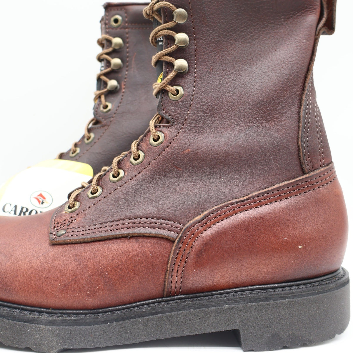 Reddish-brown Carolina lace-up work boots, close-up of stitched side and heel panels
