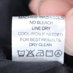 Close-up of the care-instruction label inside black and white zebra-print Erin London blazer