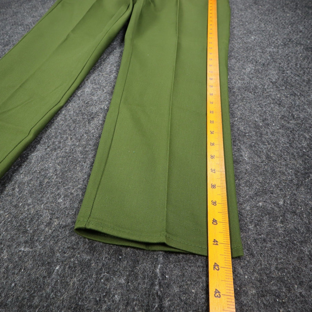 Ruler alongside the outer leg of green Aldens pants